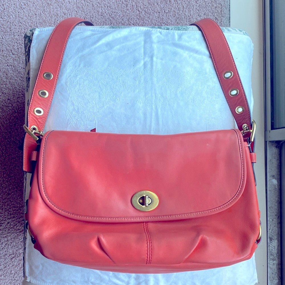 Coach used orange leather handbag.  Crossbody adjustable leather strap.